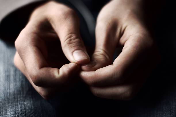 Close-up of hands resting on a lap representing a body-scan awareness practice
